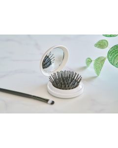 The Eloi - Brush and mirror in a recycled case